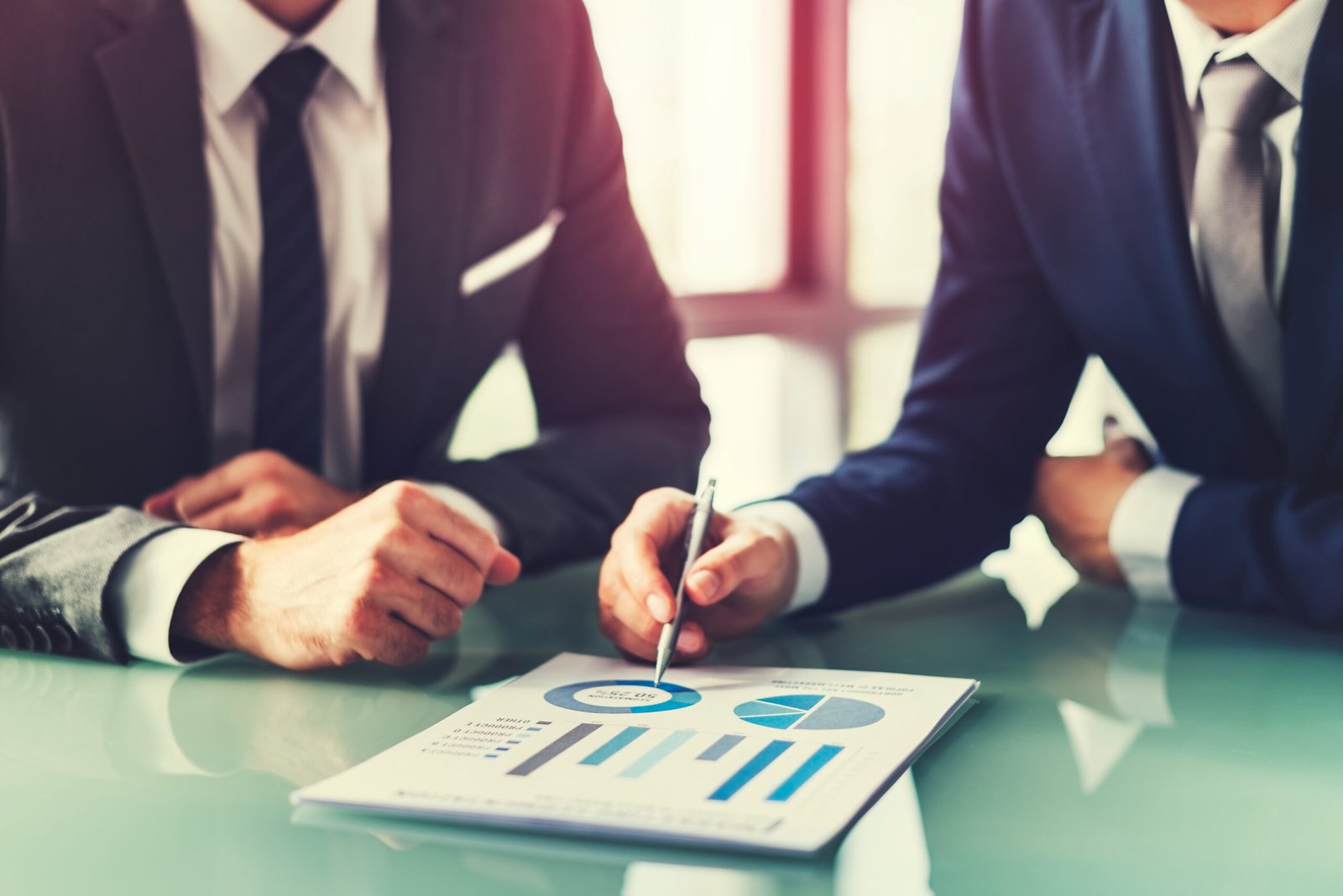 Two consultants reviewing a business performance report