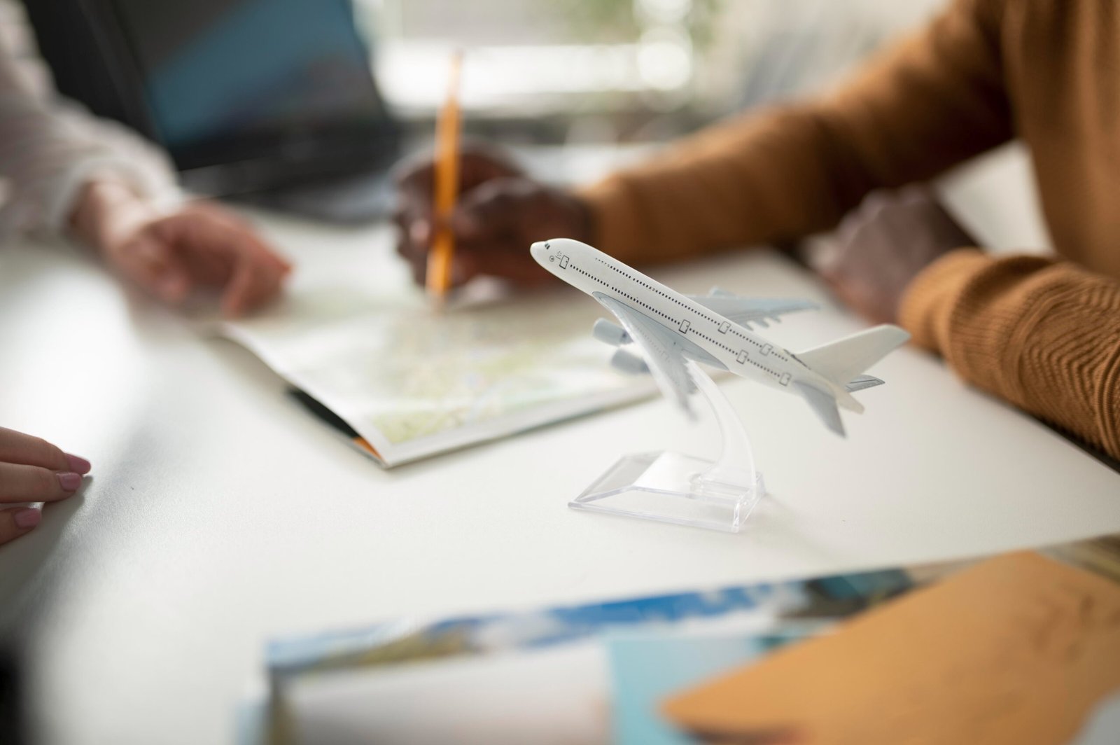 Student planning a route on a map beside a model aeroplane